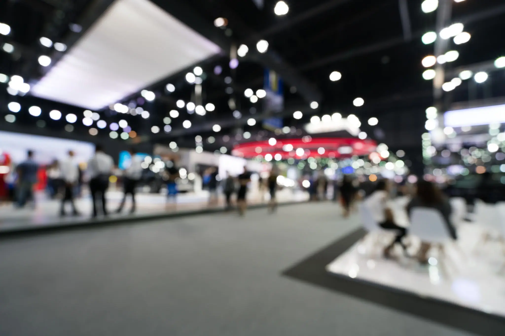 People walking in a bright exhibition hall.