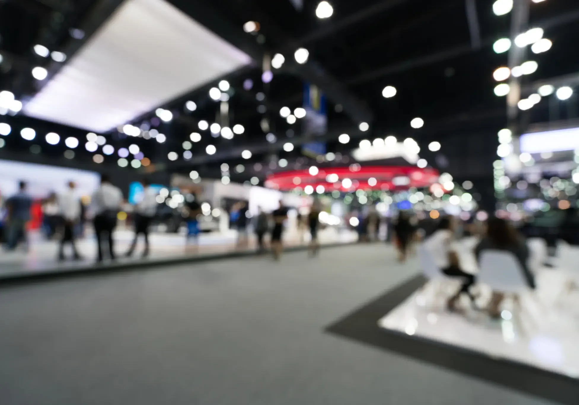 People walking in a bright exhibition hall.