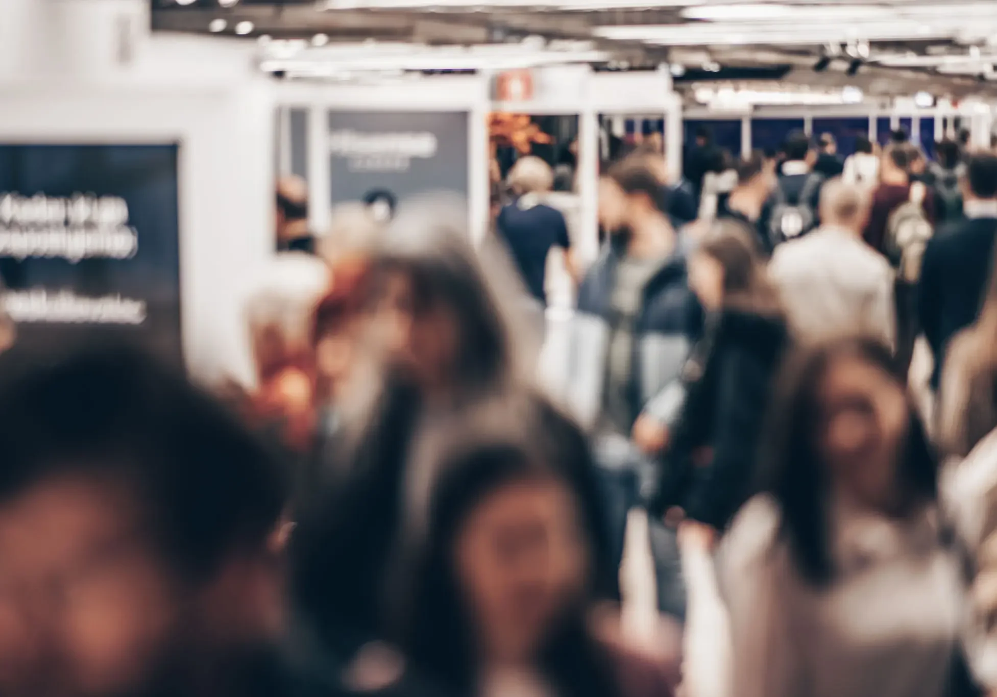 Crowded indoor event with blurred people